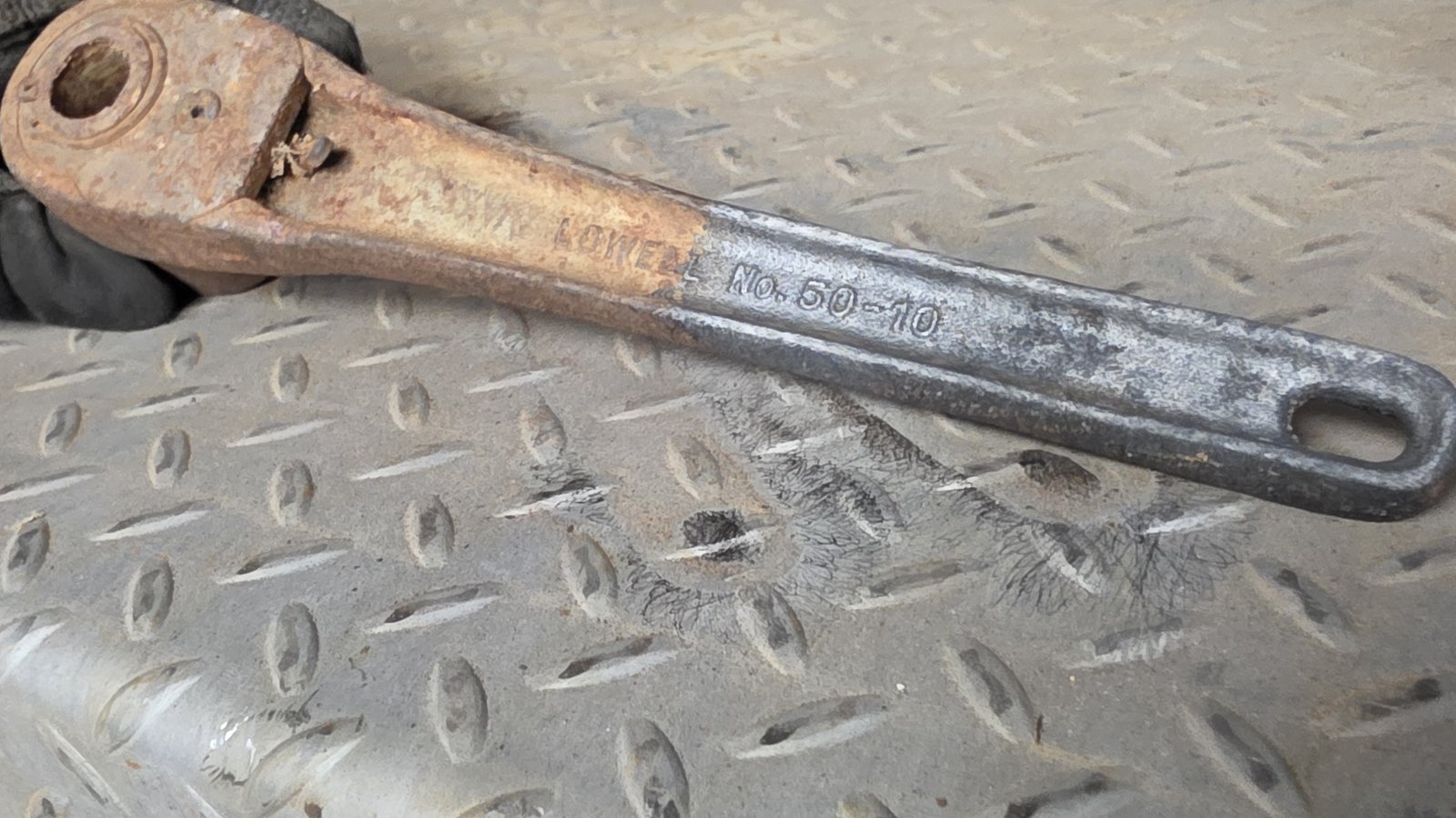 Steel wrench, rust on the head, bare metal on the cleaned handle